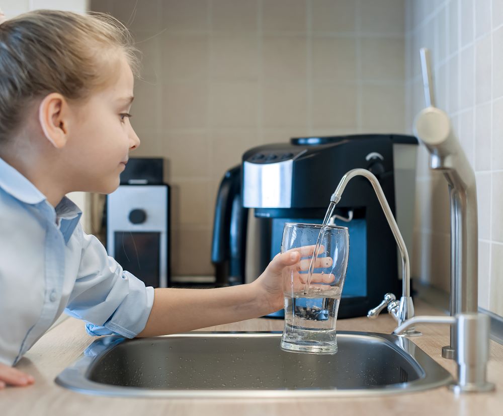 Reverse Osmosis Child Pouring Water